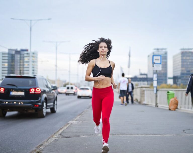 Running during pregancy Photo of Woman Listening to Music on Earphones Running Down a Sidewalk